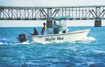 Captain Alex chasing a tarpon in our 25 foot Parker